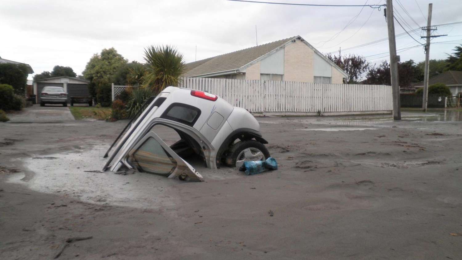 Sinking cars in Christchurch caused by Soil liquefaction